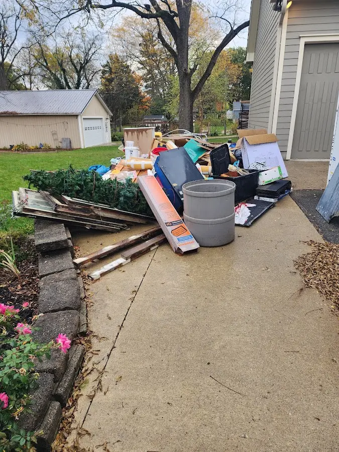 Dumpster being loaded with debris for Estate Cleanout Dumpster Rental in Valley Grande